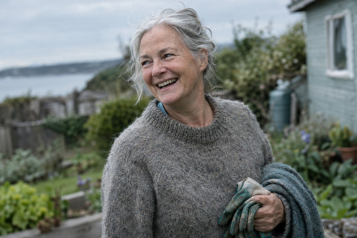 Woman in her sixties laughing in her garden, natural lines and freckles
